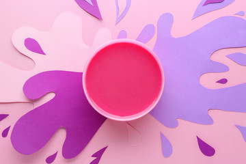 Container with sugaring paste on color background