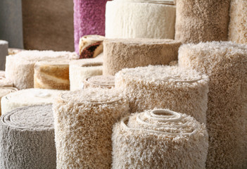 Many different carpets in shop, closeup