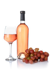 Glass and bottle of wine with grapes on white background