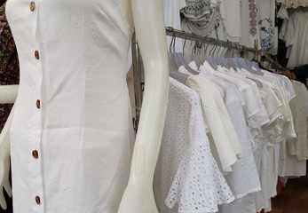 Store displays white garments on hangers