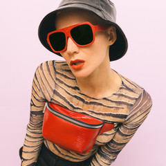 Fashion Swag Model. Stylish red accessories. Sunglasses, clutch and hipster panama cap