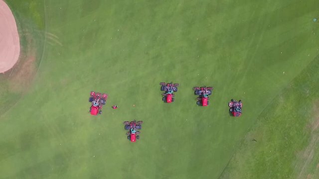 Aerial drone View Of A Groundsman mowing At Golf Course.