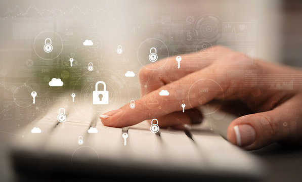 Business woman hand typing on keyboard with secured lock concept around