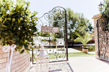 Beautifully decorated wedding ceremony location under a large oak tree, wide view.