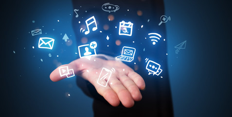 Hand holding application icons and symbols in her hand