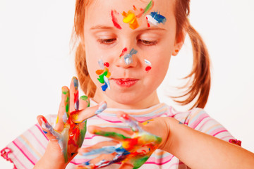 Humorous portrait of little girsl  hands painted in colorful paints