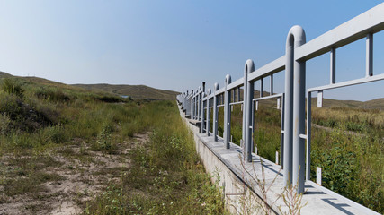 Fototapeta na wymiar Fence in field. Steppe landscape.