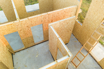 Construction of new and modern modular house. Walls made from composite wooden sip panels with styrofoam insulation inside. Building new frame of energy efficient home concept.