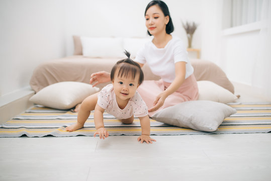 asian mother and child relaxing on the bed room