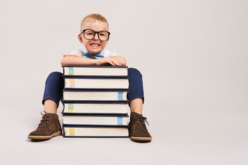 Angry boys with stack of books