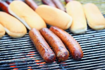Cooking hot dogs, buns and sausages on the grill