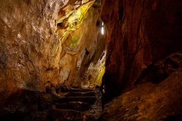 Natural high mountain cave, Mrozna cave in Tatras, yellow and brown rocks 