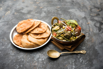 Undhiyu is a Gujarati mixed vegetable dish, specialty of Surat, India. Served in a bowl with or without poori