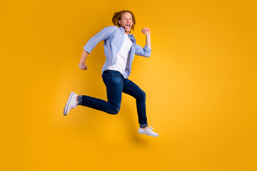 Fototapeta na wymiar Full length body size hoto of cheerful attractive handsome crazy hipster trying to gain as much speed as possible wearing jeans denim sneakers isolated over vivid color background