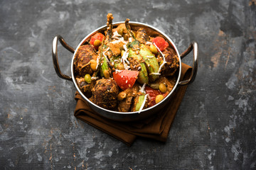 Undhiyu is a Gujarati mixed vegetable dish, specialty of Surat, India. Served in a bowl with or without poori