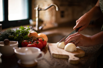 woman hands cutting vegetables in the kitchen