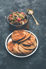 Undhiyu is a Gujarati mixed vegetable dish, specialty of Surat, India. Served in a bowl with or without poori