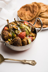 Undhiyu is a Gujarati mixed vegetable dish, specialty of Surat, India. Served in a bowl with or without poori