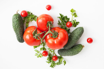 Flat lay composition with fresh cucumber, green-stuff and tomatoes on white background with copy cpace