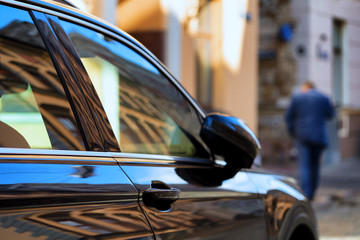 A man in a suit and a car in the city