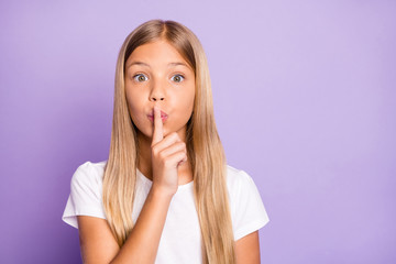 Close up photo of cute amazed shocked kid put index finger near lips say keep secret it is confidential news dont share wear style lifestyle outfit isolated over purple violet color background