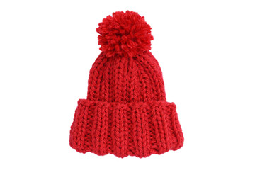 Obraz na płótnie Canvas Small red knitted bobble hat isolated on a white background. Handmade woolly hat with pompom. Closeup. Copy space