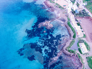Wonderful aerial view at sunset of the coastline of Portopalo, a town in the southern Sicily. The shot is taken during a beautiful sunny day at sunset