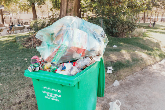 29 July 2019, Paris, France: overflowing trash can in city park