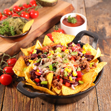 mexican nachos chips- tortilla chip with bean, guacamole, corn and cheese