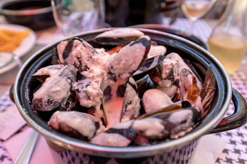 Closeup of traditional dish of French cuisine, appetizing  mussels with sauce in Pyla-sur-Mer. France