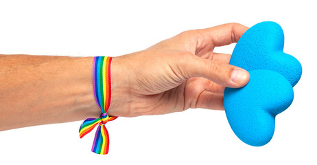 Man holds a heart in his hand. Rainbow ribbon LGBT pride. Gay with  blue heart. Isolated on a white background