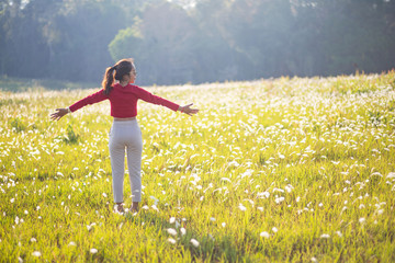 Hipster Asian woman in red and sunglasses on white flower and grass field