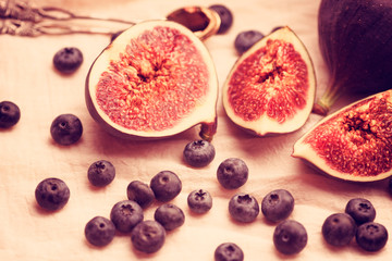 Figs and blueberries on a light background
