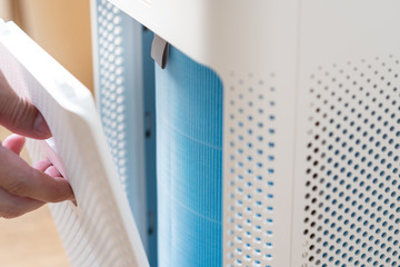 Closeup of a new air filter replaced inside the air purifier machine. Maintenance, Clean air,...