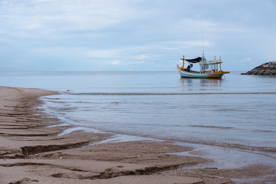Thai fishing boats parked on the shore after the fishermen had been searching for fish in the sea for several consecutive days.