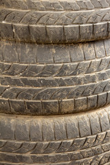 View of old tyres stacked over one another.