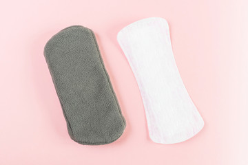 Reusable eco-friendly women's pad made of natural fabric with fleece coating for every day and ordinary female pad. Pink background, place for text, minimalism, top view, flat lay. Zero waste concept