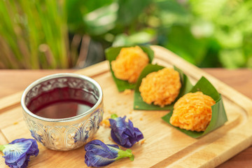 Foi Thong,  (Shredded Egg Yolk Tart) Thai desserts ingredients, used Egg yolks and sugar are boiled in sweet syrup and then formed into hairlike shapes on wood-board. Selective focus