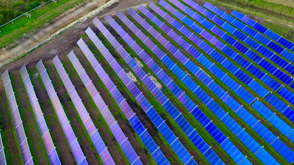 Ariel view , Shot from a drone on a farm field there are a lot of solar panels that produce environmental energy. 