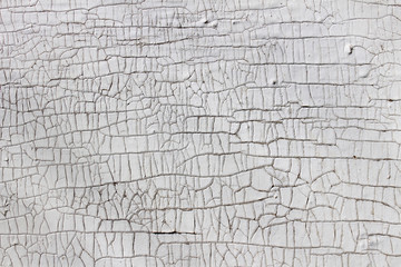White wall with cracked plaster as abstract background