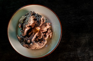 Fish liver on a plate on dark background
