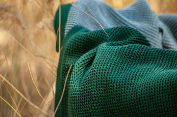 Fototapeta na wymiar Close up of green blanket on yellow grass background