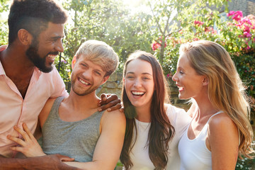 Male And Female Gay Friends At Home Having Party In Garden Together