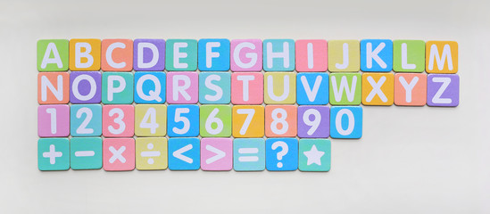 Multi-color Alphabet ABC letters and number and mathematics sign in square flat papers on white...