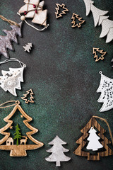 Flat lay of frame with wooden christmas tree and decoration. Copy space, winter holidays greeting card, top view.