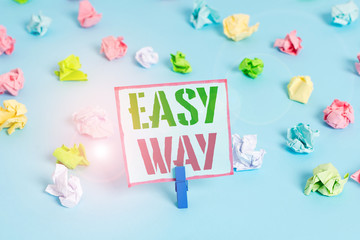 Word writing text Easy Way. Business photo showcasing making hard decision between two less and more effort method Colored crumpled papers empty reminder blue floor background clothespin
