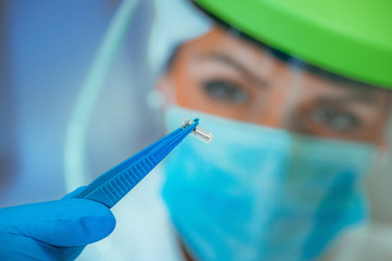 Scientist Examining RFID Implant Chip