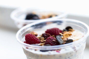 Chia pudding with yogurt, blackberries, raspberries, bananas and oatmeal served in cups