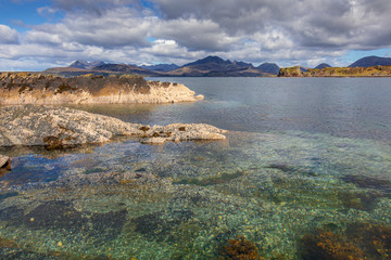 Fototapeta na wymiar The ​Isle of Skye, Scotland seascape with dramatic clouds and pristine water the Cuillins