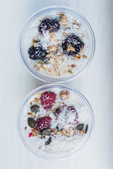 Chia pudding with yogurt, blackberries, raspberries, bananas and oatmeal served in cups